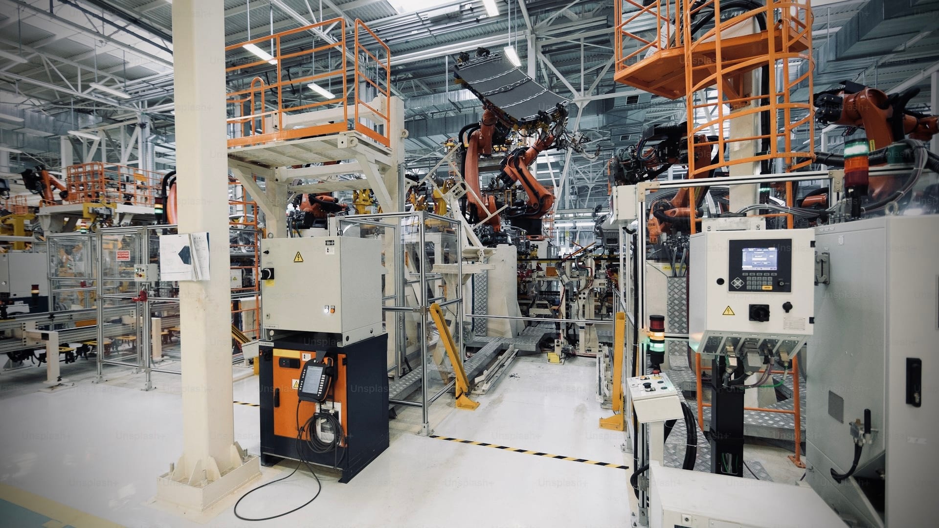 Industrial factory floor with robotic automation and control panels