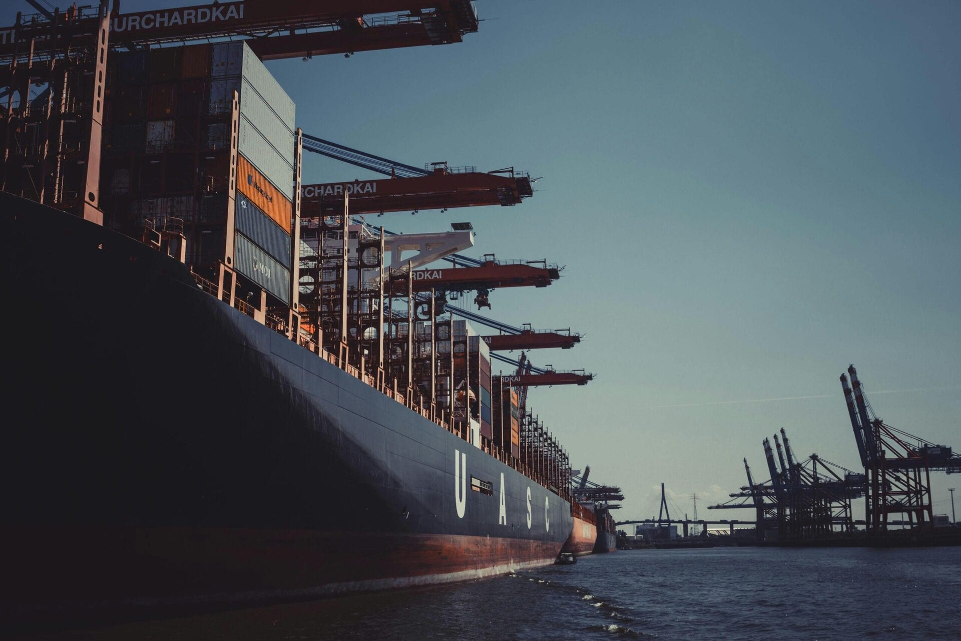 Container ship at port representing supply chain and asset tracking
